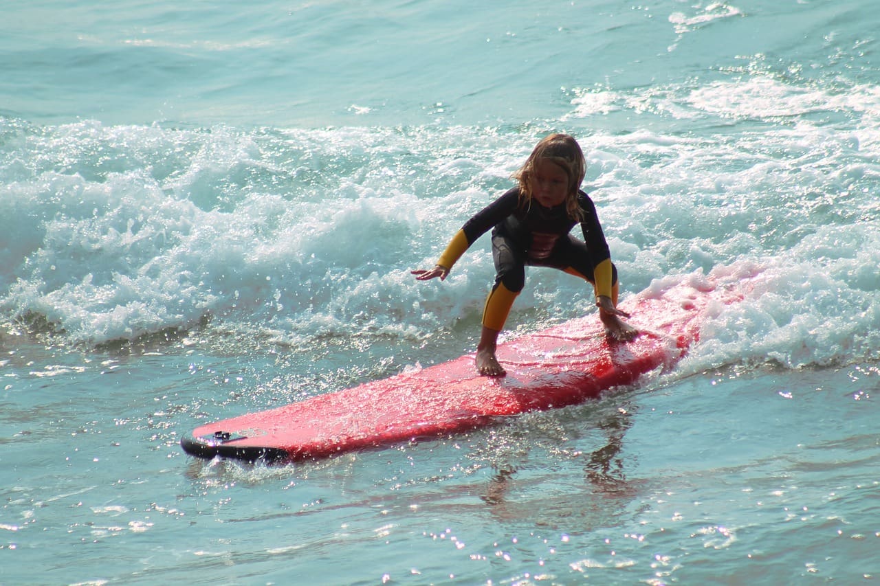 child surfing at beach
